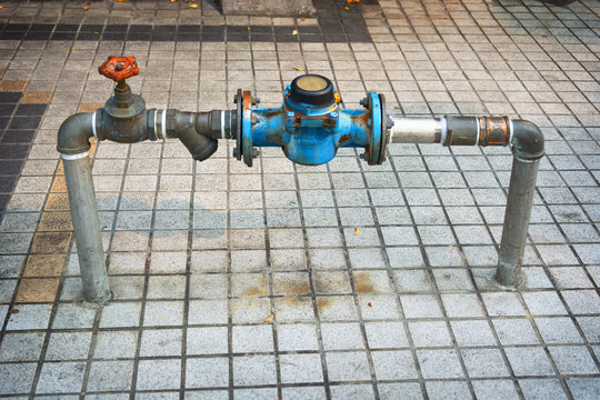 Main Water Line With Meter And Valve On Public Sidewalk