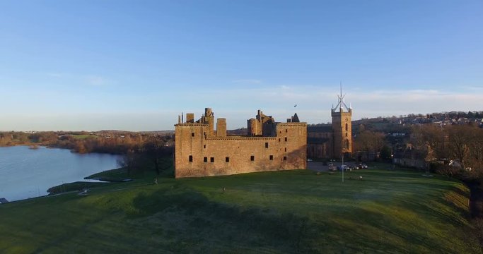 Aerial: Linlithgow Palace beside Linlithgow Loch, Scotland