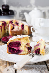 Plum cake on an old wooden table. Rustic style. Selective focus.