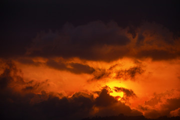 Sun's Last Orange Rays through the Clouds at Dusk