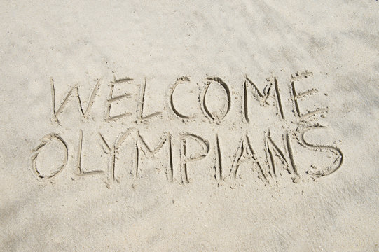 Welcome Olympians message handwritten in smooth sand on the beach in Rio de Janeiro, Brazil