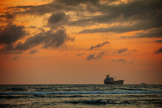 Enormous Tanker Ship on the Horizon at Sunset