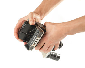 Male hands taking out a tape from an old camcorder