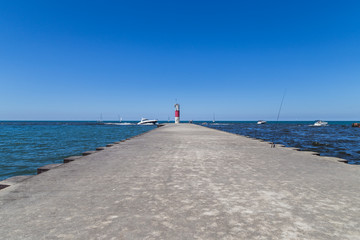 red stripe light house/beautiful summer afternoon at lake Michigan.