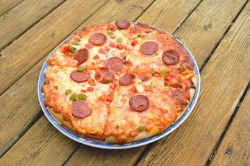 Baked pizza on a wooden table