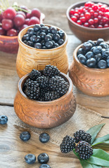 Bowl of blackberries on the wooden table