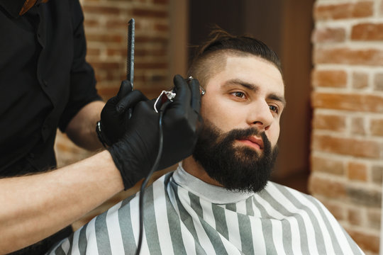 Man with dark hair doing a haircut