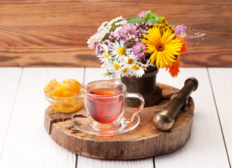 Herbal tea with honey and medicinal herbs in a mortar