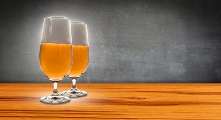 two glasses beer before chalkboard