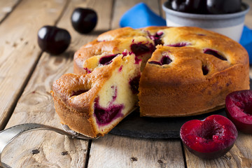 Plum cake on an old wooden table. Rustic style. Selective focus.