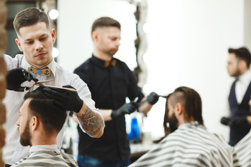 Obraz na płótnie Canvas Barbers doing haircuts for clients