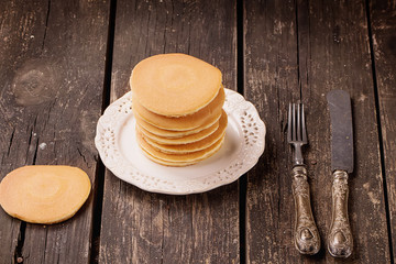 Fototapeta na wymiar Pancakes on Rustic Wooden Board