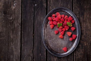 Raspberries on rustic wooden board