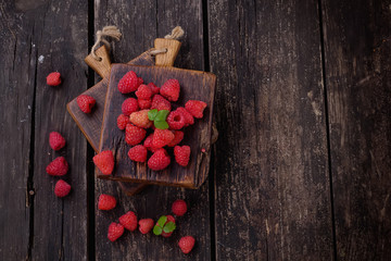 Raspberries on rustic wooden board