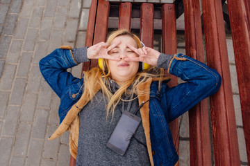 Girl listening to music streaming with headphones.