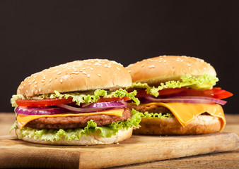 Fresh burgers on wooden background