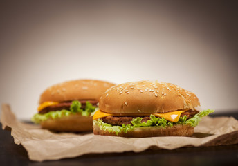 Fresh burgers on brown background