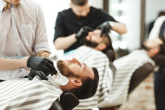 Barbers making a beard form for clients