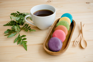 Macarons on wooden table and vintage color tone