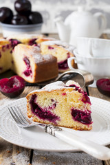 Plum cake on an old wooden table. Rustic style. Selective focus.