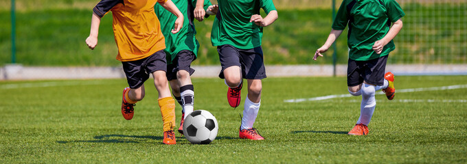 Boys playing soccer game. Horizontal sports football background. © matimix