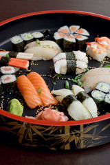 selection of Sushi on a bamboo round tray, vertical