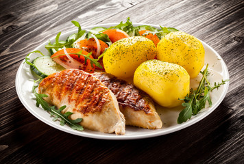 Grilled chicken fillets, boiled potatoes and vegetable salad 