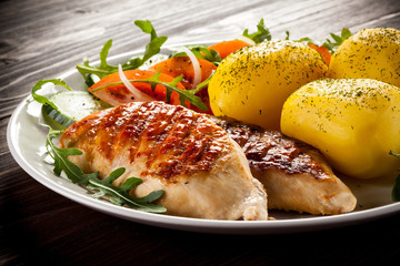 Grilled chicken fillets, boiled potatoes and vegetable salad 