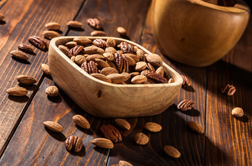 The nuts on a wooden background