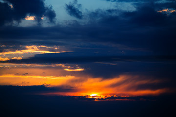 Photo of dramatic sunset with dark clouds
