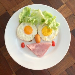 Creative funny breakfast, top view BLT braakfast on the wooden table with light 
