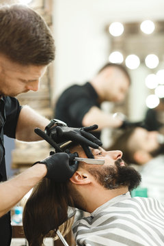 Barber making beard form for man