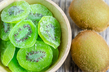 Fototapeta na wymiar Dehydrated kiwi fruits at wooden bowl, dried kiwi fruits