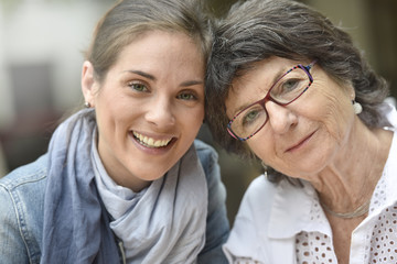 Portrait of elderly woman with home carer