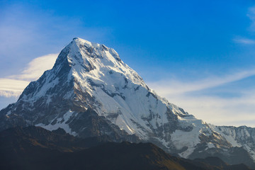 Snowy mountain with clouds.
