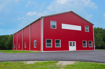 Very clean new red two story levels barn or country store with blank sign on front © Michael O'Keene
