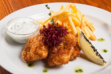 dish of meat in batter and fried potatoes