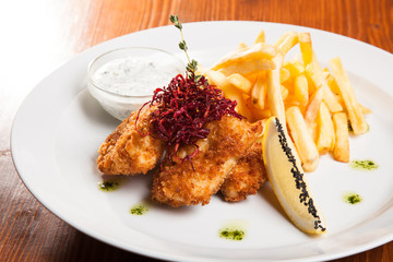 dish of meat in batter and fried potatoes
