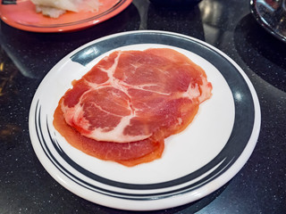 Pork on plates for suiyaki or shabu-shabu, shallow DOF, selective focus