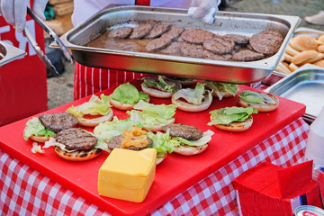 The chef prepares delicious cheeseburgers