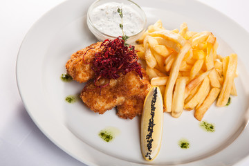 dish of meat in batter and fried potatoes