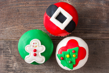 Christmas cupcakes on rustic wooden background

