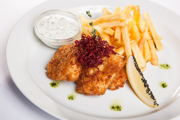 dish of meat in batter and fried potatoes