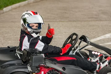 Stof per meter Go karting champion thumbs up, getting ready to race © Microgen