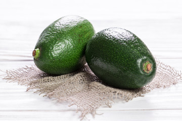 food background with fresh organic avocado on old wooden table