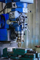 Detail of Milling machine in factory workshop.