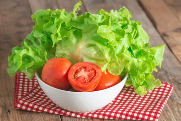 Fresh vegetable salad with green oak and tomato being prepared b