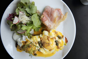 Eggs Benedict toasted English muffins,bacon, poached eggs