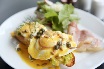 Eggs Benedict toasted English muffins,bacon, poached eggs
