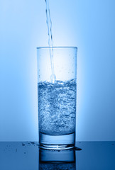 Beautiful glass with water on a blue background